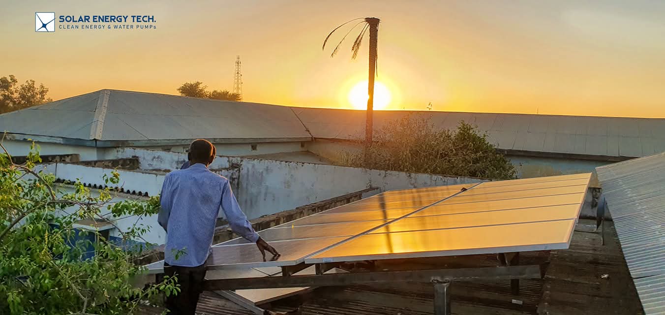 SET technician with rooftop solar panels at sunset